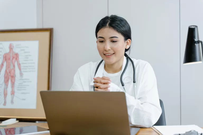 Medical students in a classroom setting, attentively listening to a lecture, representing a hands-on learning experience in a medical education